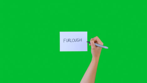 Woman-Writing-Furlough-on-Paper-with-Green-Screen